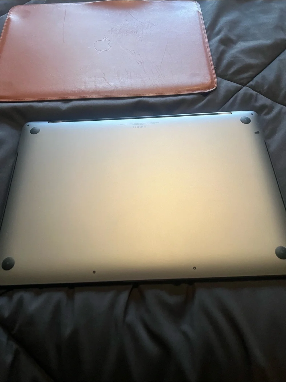 Apple Space Gray MacBook with Brown Leather Sleeve